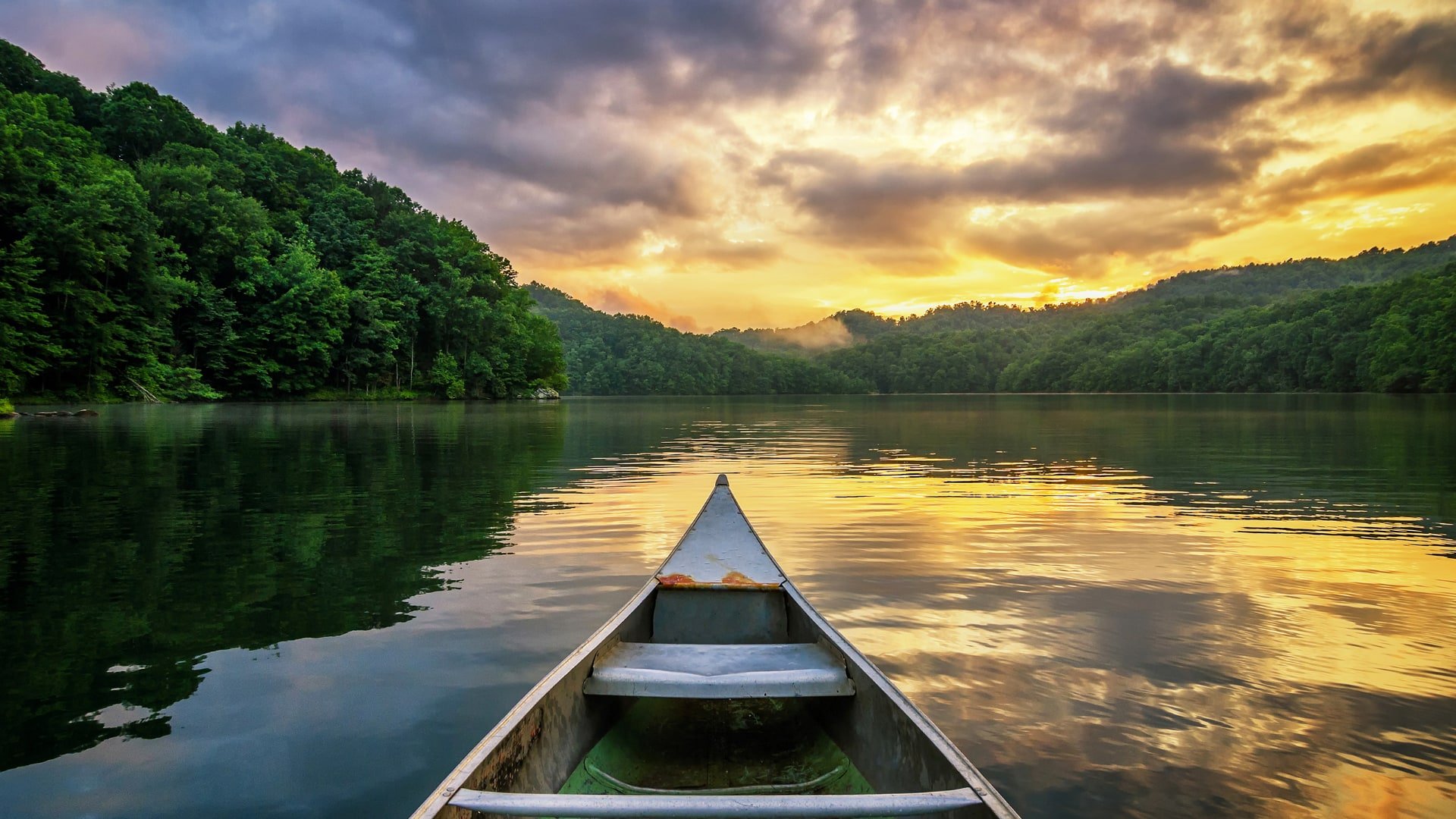 Canoe On Lake At Sunset.